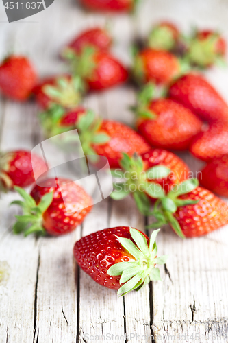 Image of Fresh red strawberries on rustic wooden background.