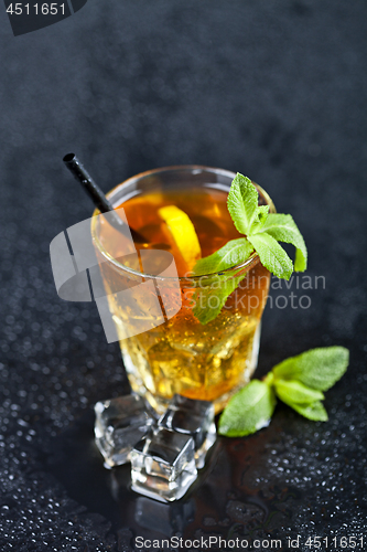 Image of Traditional fresh iced tea with lemon, mint leaves and ice cubes