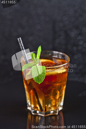 Image of Traditional fresh iced tea with lemon, mint leaves and ice cubes