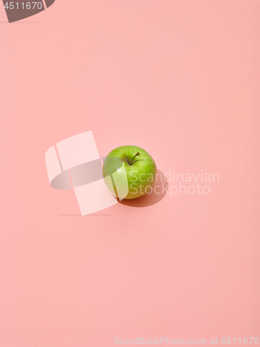 Image of green apple on pink background