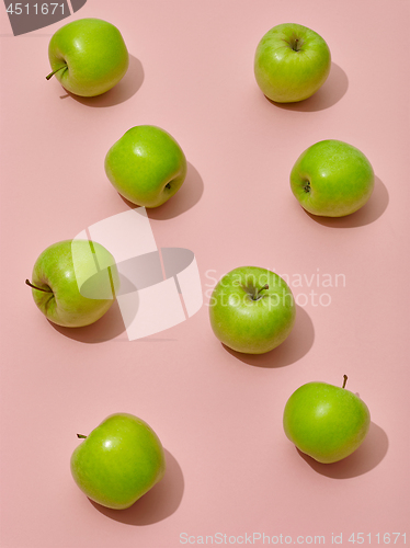 Image of green apples on pink background