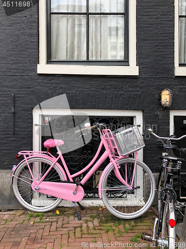 Image of  Pink bicycle on the street of Amsterdam