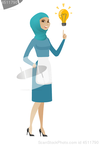 Image of Young muslim cleaner pointing at idea bulb.