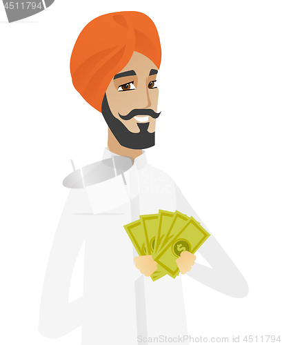 Image of Happy hindu businessman holding money.