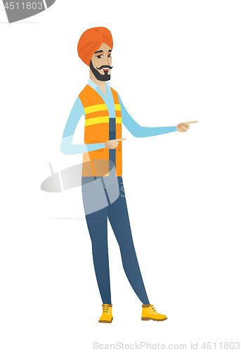 Image of Young hindu builder pointing to the side.
