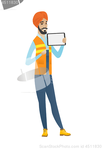 Image of Young hindu builder holding tablet computer.