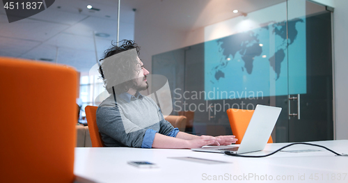 Image of businessman working using a laptop in startup office