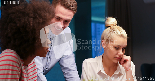 Image of Multiethnic startup business team in night office