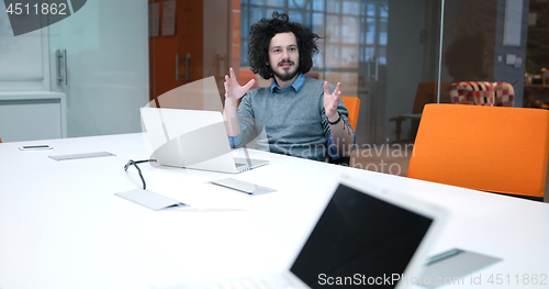 Image of businessman working using a laptop in startup office