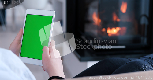 Image of woman on sofa using tablet computer