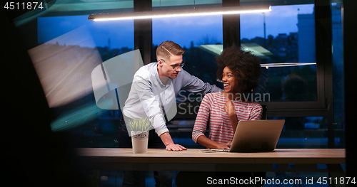 Image of Multiethnic startup business team in night office