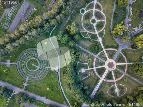 Image of Birds eye view from the drone to a Garden labyrinth and park alleys of the round form in the park.