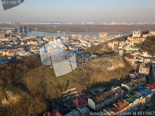 Image of A bird\'s eye view, aerial view from drone of the Podol district, oldest historical center of Kiev, Ukraine, the Dnieper River and the left bank of Dnieper