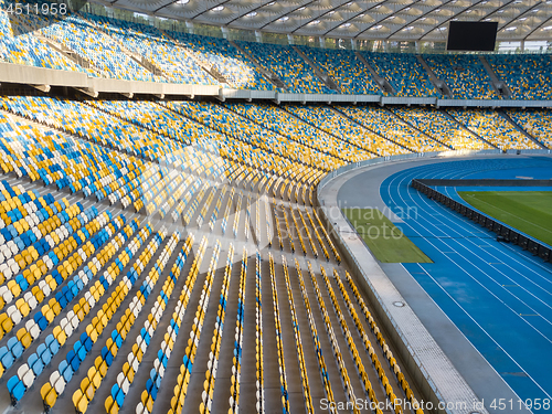 Image of KYIV, UKRAINE - July 19, 2018. The inside part of the Olympic sports complex with a football field, stands and treadmills.