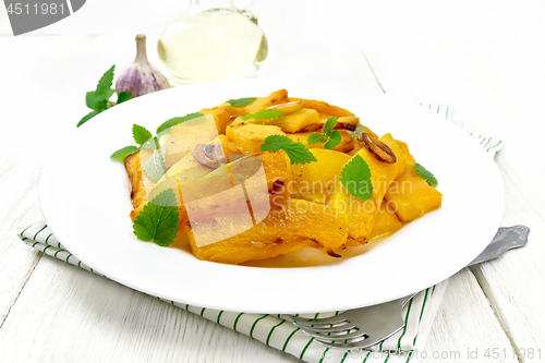 Image of Pumpkin with garlic in plate on white board