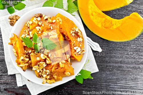 Image of Pumpkin with nuts and honey on black board top