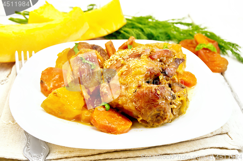 Image of Chicken roast with pumpkin and dried apricots on board 