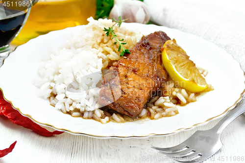 Image of Salmon with sauce in plate on wooden board