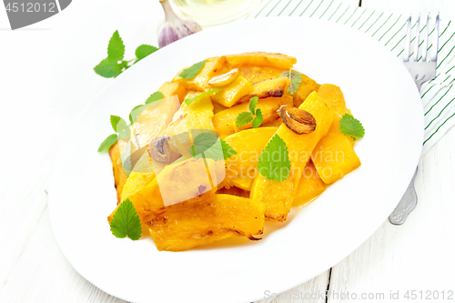 Image of Pumpkin with garlic in plate on board