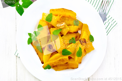 Image of Pumpkin with garlic in plate on board top