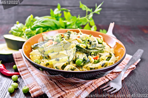 Image of Tagliatelle with green vegetables on napkin