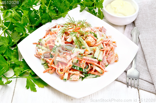 Image of Salad of sausage and spicy carrots with mayonnaise on light tabl