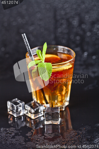 Image of Traditional fresh iced tea with lemon, mint leaves and ice cubes