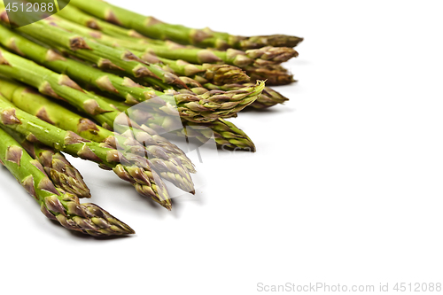 Image of Bunch of fresh raw garden asparagus closeup on white background.