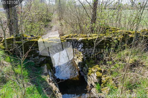 Image of Ancient moss covered brick stone bridge on the swedish countrysi