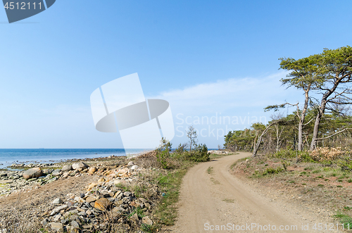 Image of Beautiful winding gravel road by the coast
