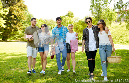 Image of friends with guitar going to picnic at park