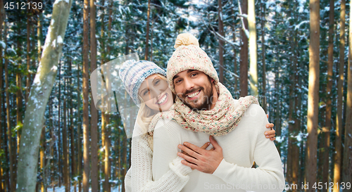 Image of couple hugging over winter forest background