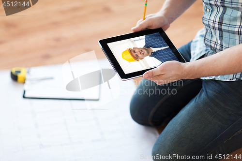 Image of man having video call with builder on tablet pc