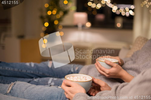 Image of close up of couple drinking hot chocolate at home