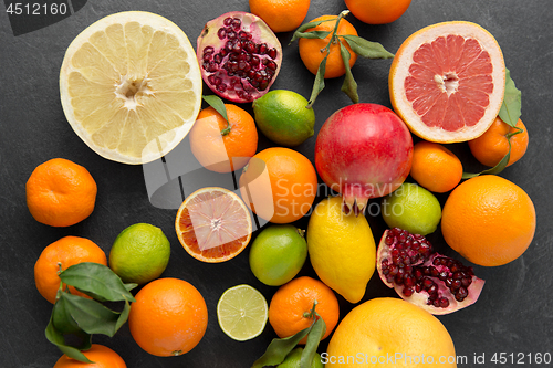 Image of close up of citrus fruits on stone table