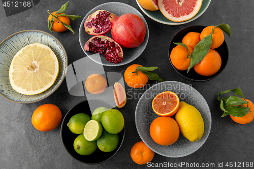 Image of close up of citrus in bowls fruits on stone table