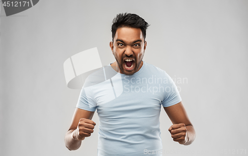 Image of angry indian man screaming over grey background
