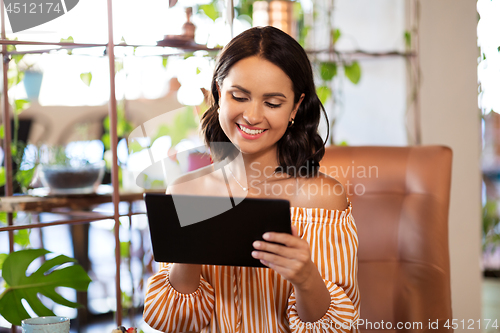 Image of happy woman with tablet pc at cafe or coffee shop