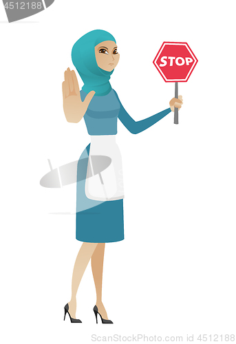 Image of Young muslim cleaner holding stop road sign.