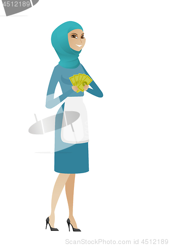 Image of Young muslim cleaner holding money.