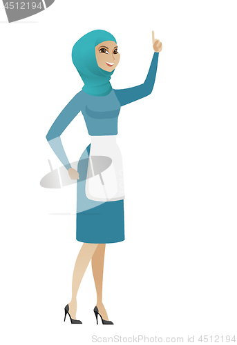 Image of Young muslim cleaner pointing with her forefinger.