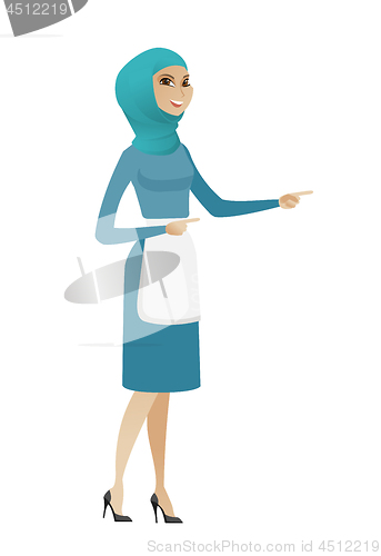 Image of Young muslim cleaner pointing to the side.