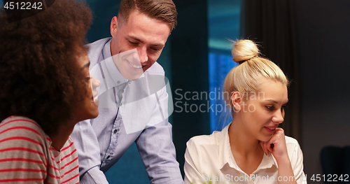 Image of Multiethnic startup business team in night office