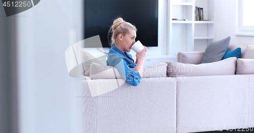 Image of woman enjoying a cup of coffee