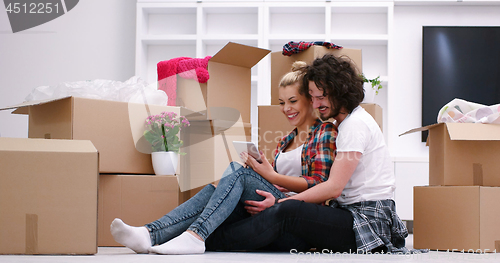 Image of young couple moving  in new house