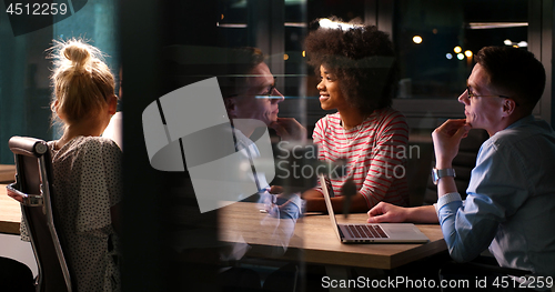 Image of Multiethnic startup business team in night office