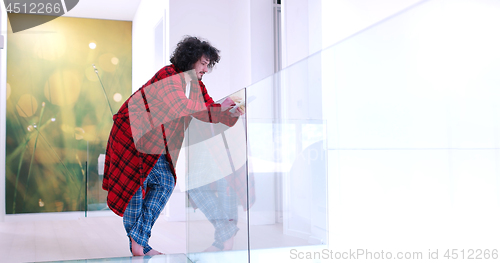 Image of young man using a tablet at home