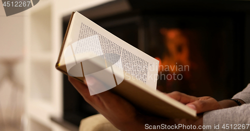 Image of black woman at home reading book