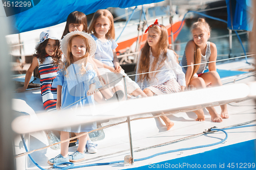 Image of The children on board of sea yacht