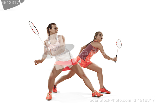 Image of Young women playing badminton over white background